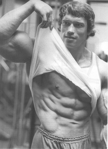 Arnold showing of his flat stomach