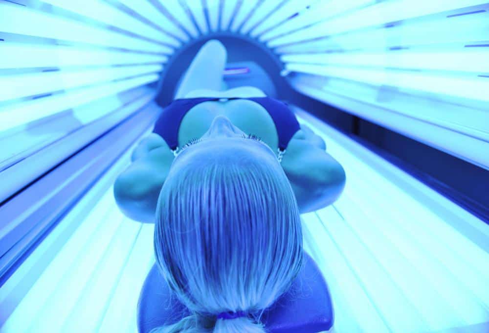 woman getting UVB light in a tanning bed