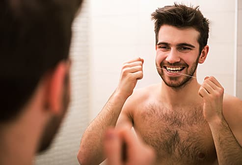 man flossing for good oral hygiene