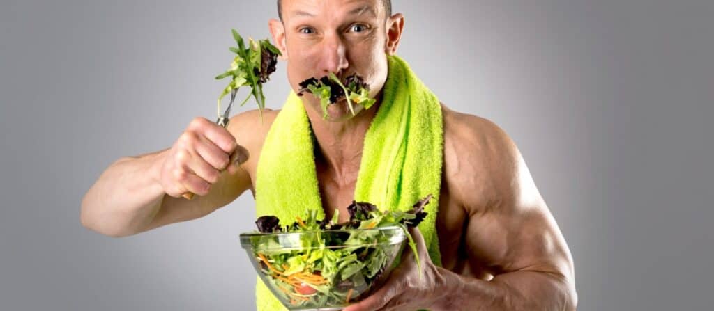 fit man eating a salad as weight loss food