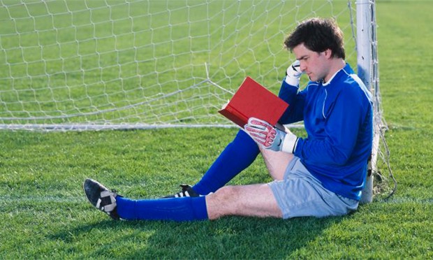 athlete reading soccer books