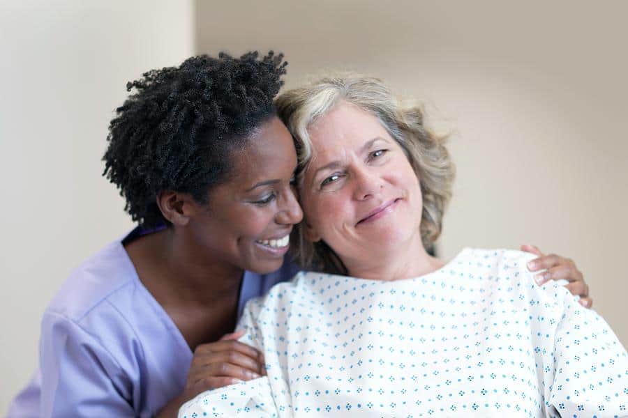 nurses comforting female patient