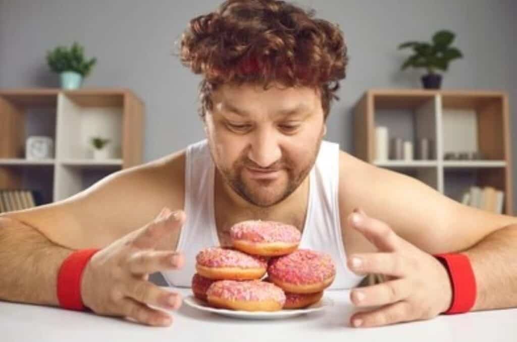 chubby athlete eating sweets after a workout